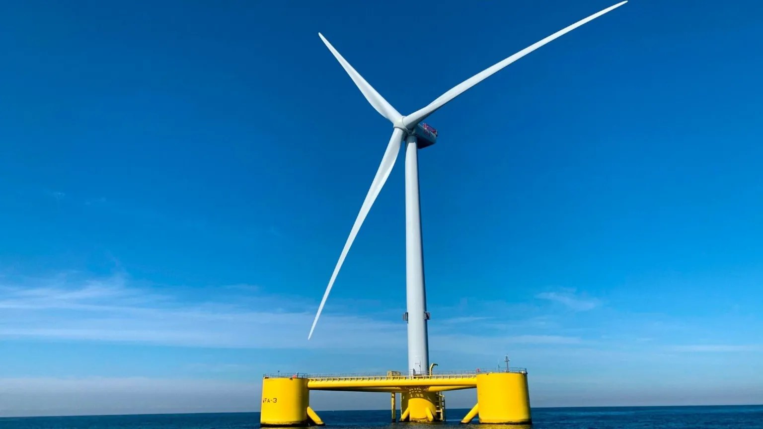 Floating offshore wind turbine at sea under a cloudy sky