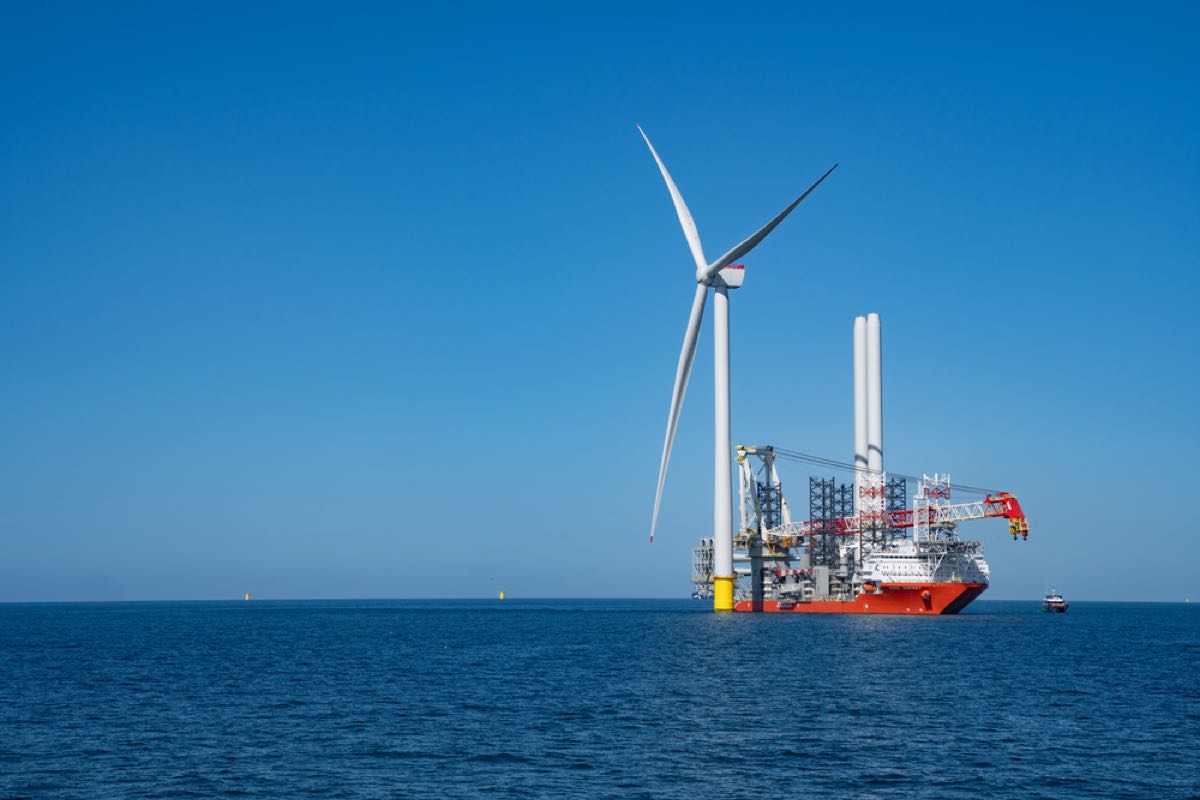 The first turbine at East Anglia THREE with a jack-up installation vessel alongside